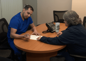 a person and person sitting at a table