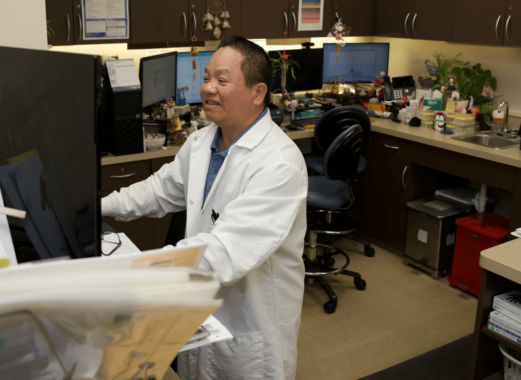 a person in a lab coat in a room with computers
