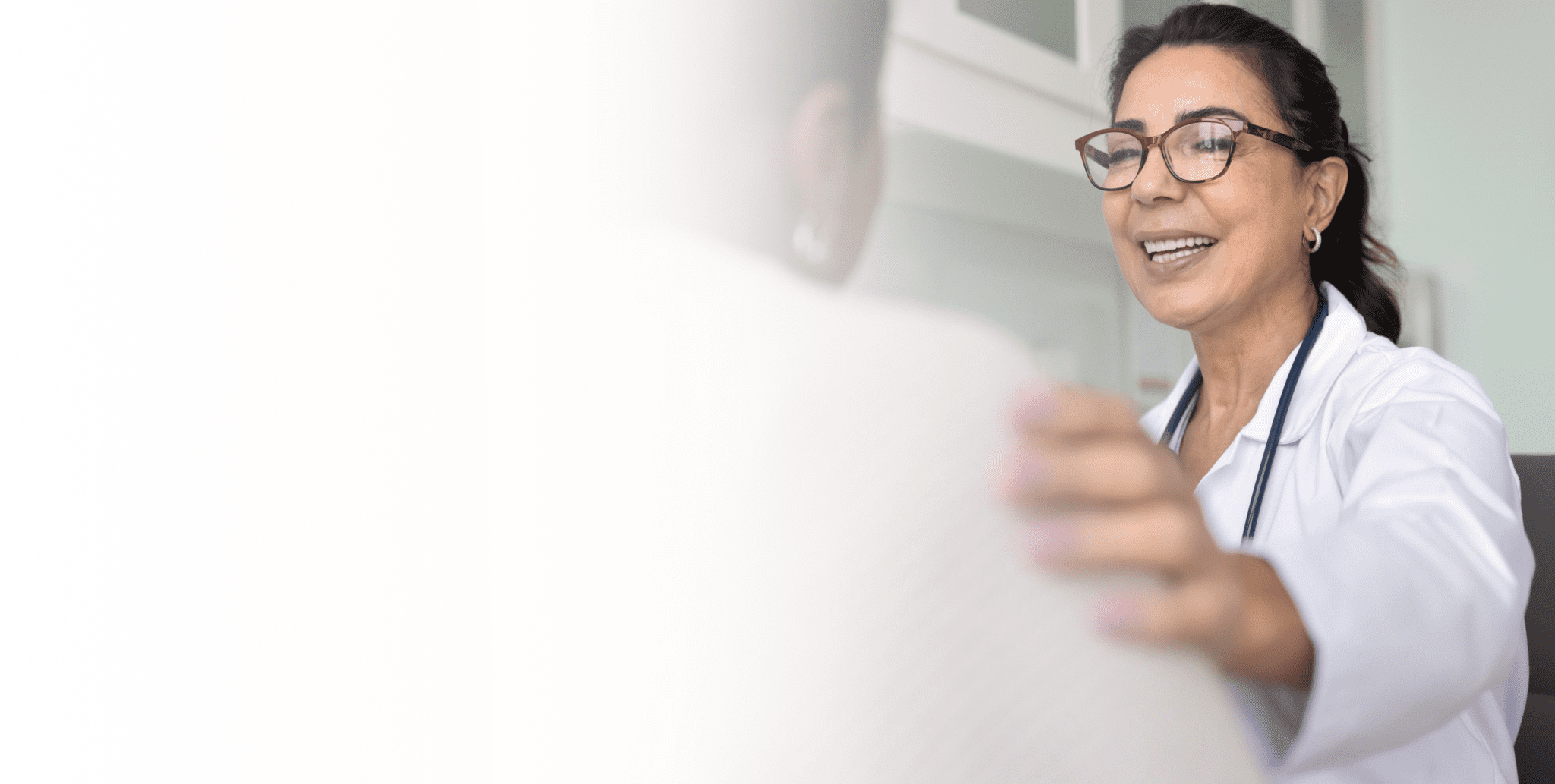 a person smiling and looking at a white board