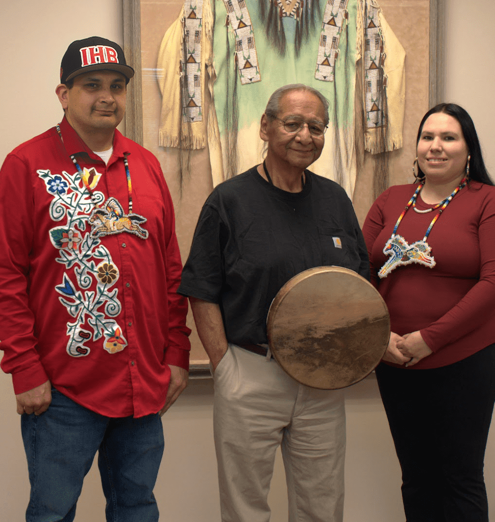 a group of people standing in front of a painting