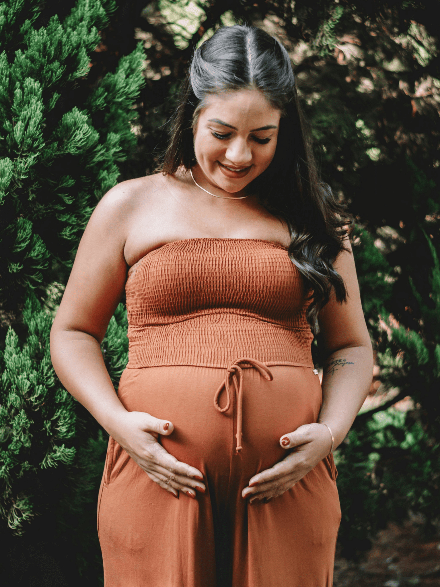 a pregnant person holding her belly