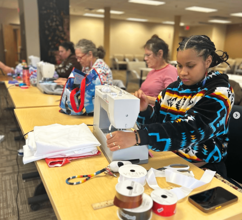 a person sewing on a sewing machine