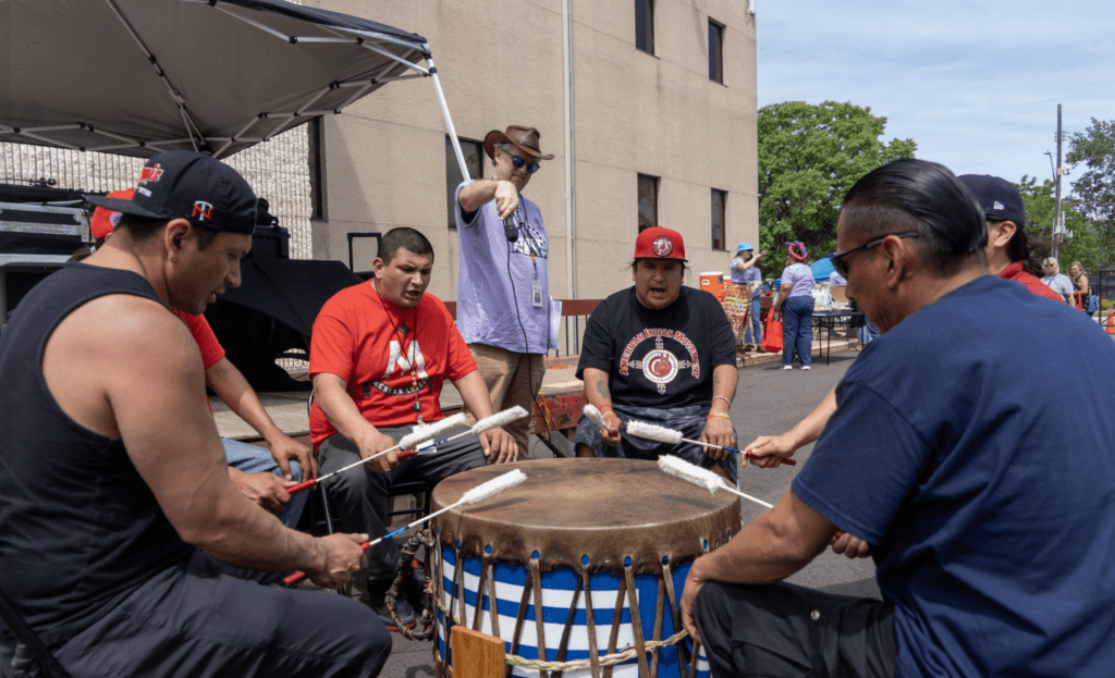 a group of men playing drums outside