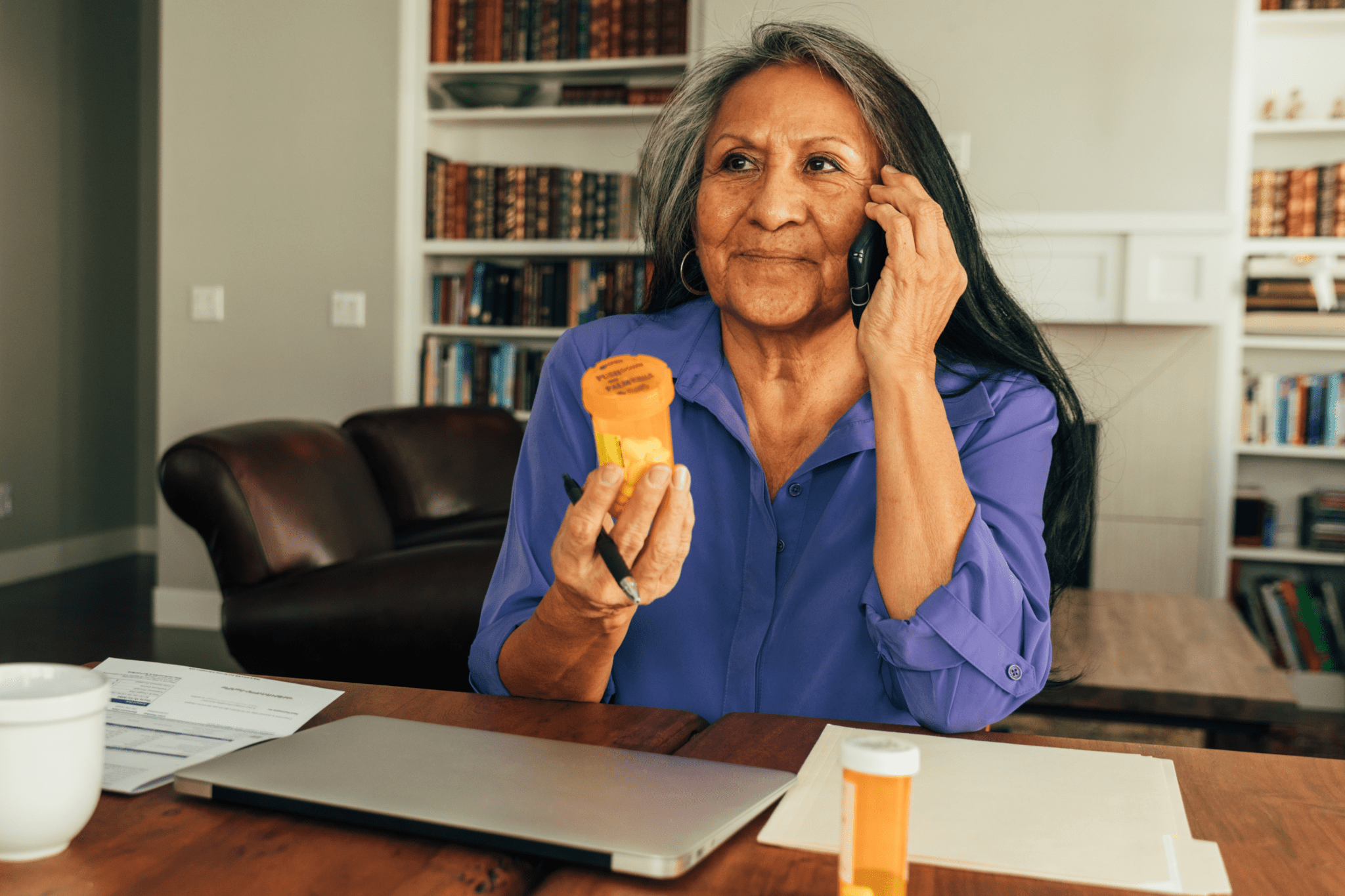 a person holding a phone and a pen