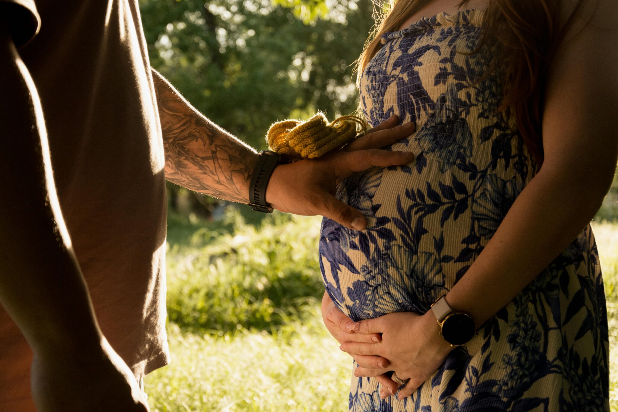 a person holding a pregnant person's belly