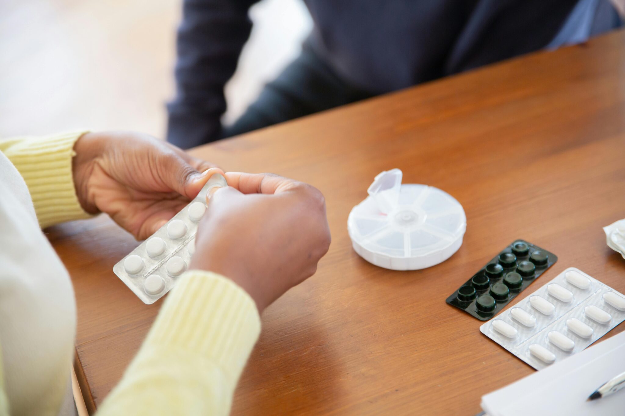 a person holding a pack of pills